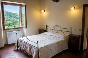 a bedroom with a bed and a large window at APPARTAMENTI Vista del Mondo in Spoleto