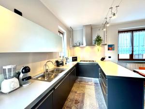 a kitchen with a sink and a counter at Villa Elvira fronte lago di Como by Gottschalk in Dervio