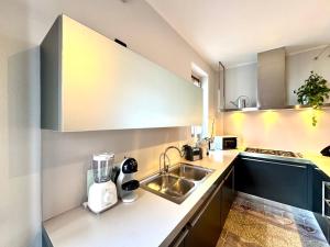 a kitchen with a sink and a counter top at Villa Elvira fronte lago di Como by Gottschalk in Dervio