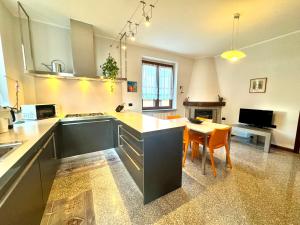 a kitchen with a table and a dining room at Villa Elvira fronte lago di Como by Gottschalk in Dervio +40 photos