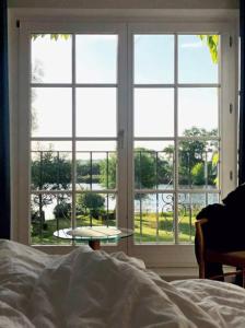 a bedroom with a bed and a large window at Dorotheenhof in Mescherin