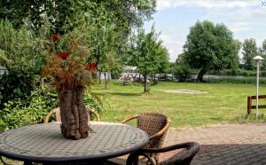 a table with a vase of roses on it at Dorotheenhof in Mescherin +2 photos