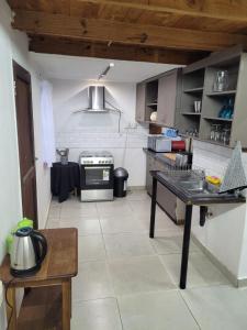 a kitchen with a table and a stove in it at Dream Big Bougainvillea 2 bedroom cottage in Centurion