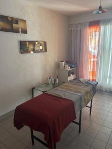 a room with a bed and a table and a window at Barrio La Victoria in Ezeiza