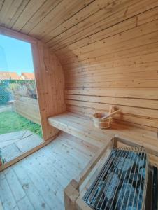 a wooden sauna with a large window in it at Le Box Circuit Magny-Cours in Saint-Parize-le-Châtel