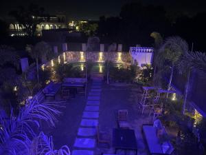 an outdoor patio at night with blue lights at Vista villa in Pushkar