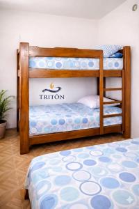 two bunk beds with the t nation logo on them at Casa de Playa Triton in Máncora