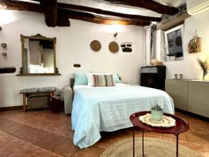 a bedroom with a large bed and a table at Casa Zita Cozy • AC near Lake Como by Gottschalk in Olgiasca