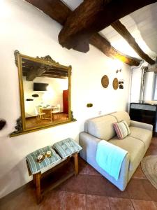 a living room with a couch and a mirror at Casa Zita Cozy • AC near Lake Como by Gottschalk in Olgiasca +29 photos