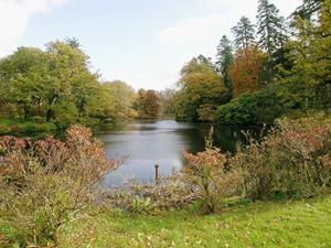 a view of a river with trees and a field at The Coach House in Girvan