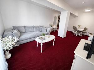 a living room with a couch and a table at Hotel Sebastian u Hoffera in Modra