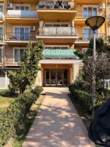 a building with a walkway in front of it at Seyra Home Studio - Modern Flat Pool Free Parking Self Check-in in Ştefăneştii de Sus