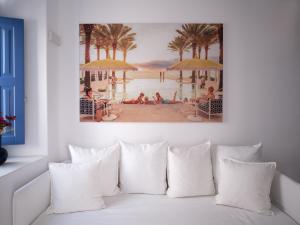 a painting of people on a beach with umbrellas at Chiara Mykonos in Mikonos
