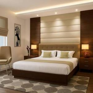 a bedroom with a large bed and a chair at روف كامل خصيصا لك in Madīnat ash Shurūq