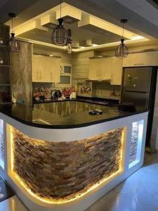 a kitchen with a stone counter in a room at روف كامل خصيصا لك in Madīnat ash Shurūq