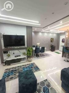 a living room with a flat screen tv on a wall at روف كامل خصيصا لك in Madīnat ash Shurūq