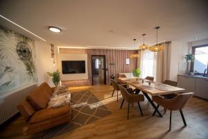 a living room with a table and a couch at Boho vibes between mountains and lakes in Schlier