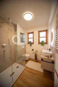 a bathroom with a shower and a toilet and a sink at Boho vibes between mountains and lakes in Schlier +13 photos