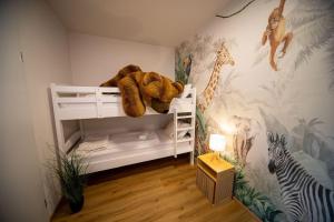 a bedroom with a white bunk bed with a stuffed animal at Boho vibes between mountains and lakes in Schlier