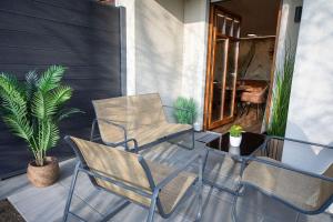 two chairs and a table on a patio at Boho vibes between mountains and lakes in Schlier