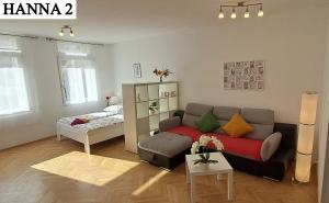 a living room with a couch and a bed at Hanna Apartman 1-2 in Kőszeg