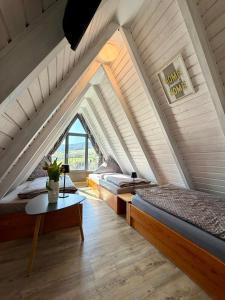 two beds in a room with an attic at Ferienhaus in der Rhön Sitzmann in Bischofsheim an der Rhön
