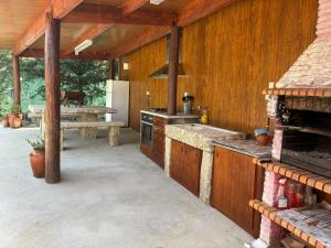 an outdoor kitchen with a stove and a table at Bungalow da Pedreira in Viseu +19 photos
