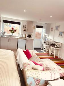 a living room with a couch and a kitchen at Jayslin in Felpham