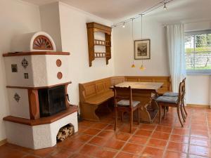 a living room with a wood stove and a table at See & Natur Apartment Uffing in Uffing