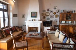 a living room with a couch and a fireplace at Aegean Panorama in Klíma