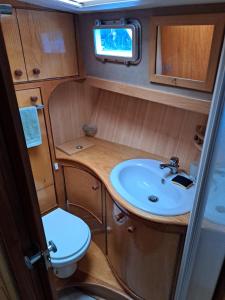 a bathroom with a sink and a toilet in an rv at Bleu soleil in Dieupentale