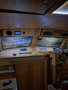 an interior view of a kitchen in a boat at Bleu soleil in Dieupentale