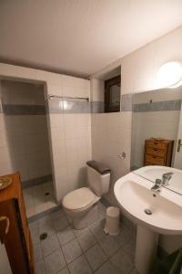 a bathroom with a toilet and a sink at Aegean Panorama in Klíma +25 photos