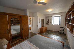 a bedroom with a bed and a cabinet and a room at Aegean Panorama in Klíma