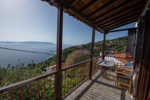 a balcony of a house with a view of the ocean at Aegean Panorama in Klíma