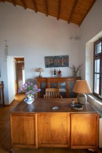 a living room with a wooden table with flowers on it at Aegean Panorama in Klíma