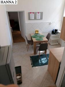 a kitchen with a table and chairs in a room at Hanna Apartman 1-2 in Kőszeg