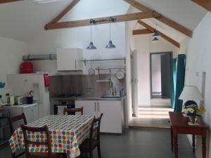 a kitchen with a table with a table cloth on it at Rhiwiau Self Catering in Carmarthen