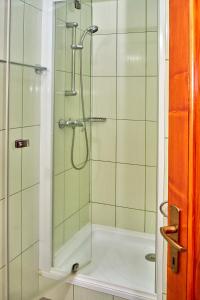 a bathroom with a shower with a glass door at Muskatli Villa in Sovata