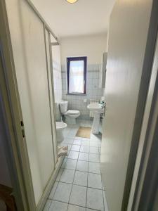 a bathroom with two toilets and a sink at Sotto i Monti House in Nicolosi +11 photos