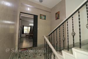 a staircase in a house with a hallway at Sai International Guest House in kolkata