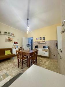 a kitchen and living room with a table and chairs at Sotto i Monti House in Nicolosi