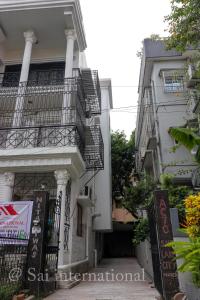 a white building with stairs and balconies at Sai International Guest House in kolkata