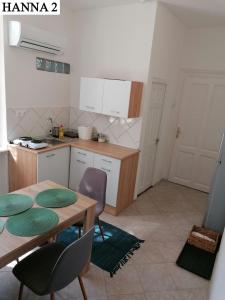 a kitchen with a table and chairs in a room at Hanna Apartman 1-2 in Kőszeg +1 photo