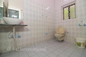a bathroom with a sink and a toilet at Sai International Guest House in kolkata