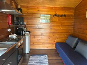 a small kitchen with a couch and a stove at Bungalow da Pedreira in Viseu