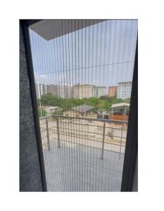 a glass window with a view of a city at De Crystal Place in Ikate