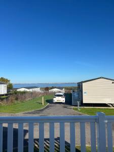 a car parked on a road next to a building at haven kent coast in Allhallows