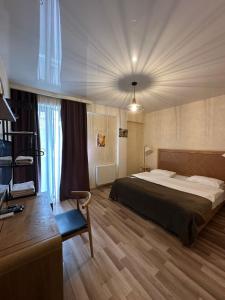 a hotel room with a bed and a desk and a desk at Amber Boutique Hotel in Tbilisi City