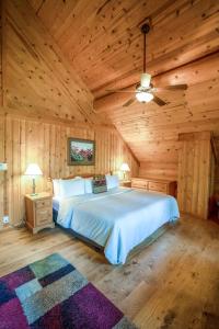 a bedroom with a bed in a wooden cabin at Mike Wiegele Helicopter Skiing in Blue River